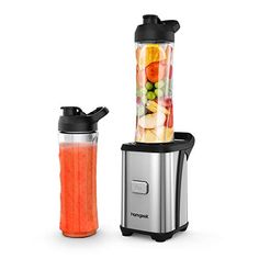 two blenders filled with different types of fruits and vegetables next to each other on a white surface