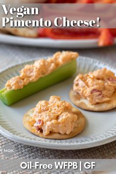 three small crackers on a plate with dip and tomatoes in the background, along with other appetizers