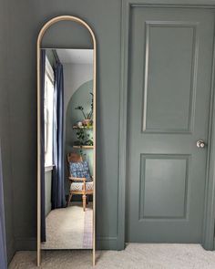 a large mirror sitting next to a doorway