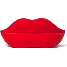 a red lip shaped object sitting on top of a white surface