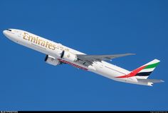 an emirates airplane flying in the blue sky