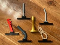 three different types of woodworking tools sitting on a table with rope and pliers