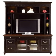 a black entertainment center with drawers and a flat screen tv