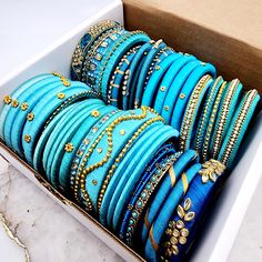 ** Clearance Sale buy 1 box for $25 or BUY 2 for $40** Discover a vibrant array of colors and unique styles with our Clearance Banglez Box, featuring exquisite silk, metal, and stone bangles. Each box has a variety of mixed sizes. These bangles bring a touch of traditional elegance to your collection, making them ideal for a wide age range and style preferences. Perfect for party favors and giveaways, these bangles add a festive touch to any celebration. *Please note: these items are as-is, impe Festive Gift Bangle, Handmade Bollywood Style Bracelets For Gifts, Traditional Blue Bangle For Gift, Blue Bangle As A Festival Gift, Traditional Assorted Jewelry As A Gift, Traditional Assorted Jewelry For Gift, Blue Bracelets For Festivals As A Gift, Blue Bracelets For Festivals And Gifts, Blue Bracelets Gift For Festivals