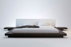 a modern bed with white sheets and pillows