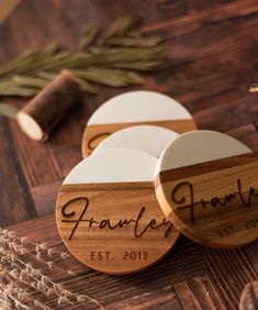 three personalized wooden coasters sitting on top of a table