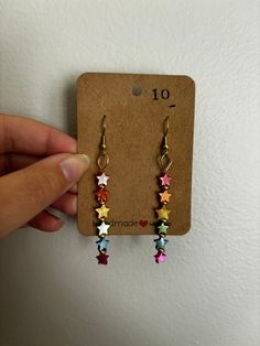 Handmade rainbow stars dangle earrings. Hooks are gold plated steel and nickel free. Approximate size: 2 inches long, 0.25 inches wide. Rainbow Dangle Metal Earrings, Rainbow Metal Earrings With Ear Wire, Rainbow Metal Earrings, Rainbow Dangle Earrings With Ear Wire, Rainbow Metal Drop Earrings, Multicolor Star Earrings, Rainbow Dangle Earrings, Trendy Multicolor Star-shaped Jewelry, Trendy Multicolor Star Jewelry