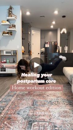 a woman is doing yoga on the floor in front of a living room and kitchen