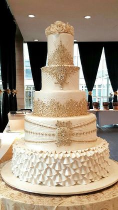 a large white wedding cake sitting on top of a table