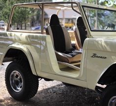 an old jeep is parked on the side of the road