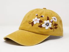 Flower is 100% hand embroidered on a 100% cotton wash baseball cap. Hat is one size fits all with adjustable back strap. Unique cap, one of a kind! I am also open for customization. If you want the item in different colors, please message me, it will take additional 2-3 days of handling time. Free first class shipping, upgradable priority mail service. 30 days return policy, feel confident at your purchase! Vintage Baseball Cap With Curved Visor For Spring, Spring Adjustable Snapback Hat With Curved Visor, Yellow Baseball Cap For Spring, Yellow Snapback Dad Hat For Spring, Yellow Snapback Baseball Cap For Spring, Yellow Snapback Hat For Spring, Yellow Adjustable Dad Hat For Spring, Embroidered Adjustable Snapback Hat For Spring, Floral Embroidery Adjustable Snapback Baseball Cap