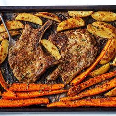 steak and potatoes on a tray with a fork sticking out of the top, ready to be eaten