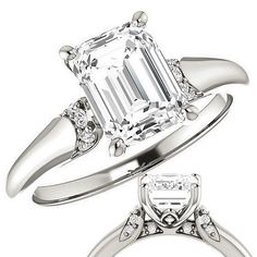 an emerald cut engagement ring with three side stones on the band and a diamond set in the middle