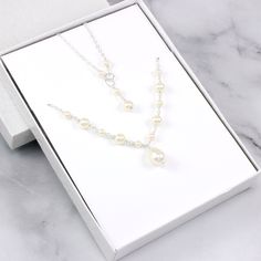 This beautiful bridal necklace is made with Swarovski pearls and sterling silver. Perfect as wedding jewelry for the bride! Shown pearl color is ivory but white and cream colors are also available. Each pearl is carefully hand-wired and connected together one-by-one. The clasp of the necklace is made with small wired pearls. It's perfect for a wedding or a special occasion. Sterling silver Cable chain with spring clasp Swarovski pearls Wire: sterling silver Necklace extender available here: http White Pearl Bridal Accessories With Pearl Drop, White Pearl Drop Bridal Accessories, Wedding Bridal Pearl Necklace In Cream, Cream Pearl Necklace With Pendant For Wedding, Cream Pearl Bridal Necklace For Wedding, Cream Pearl Drop Necklace For Wedding, Cream Pearl Pendant Necklace For Wedding, Elegant Cream Pearl Necklace For Wedding, Pearl White Wedding Necklace With Pearl Drop