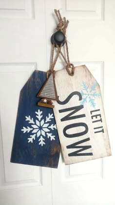 two snow themed tags hanging from a door