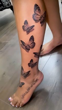 a woman's legs with butterflies on them