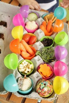 there are many different bowls and spoons on the table