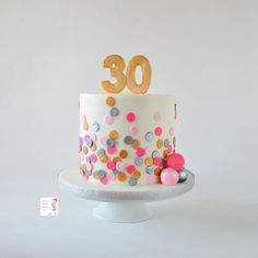 a birthday cake decorated with confetti and the number 30 on it's top