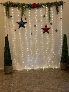 christmas decorations with lights and stars on the wall