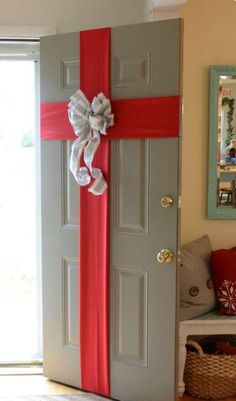 the door is decorated with red and white ribbons