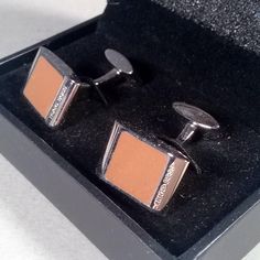 Elegant Hugo Boss cufflinks in shiny polished brass give a sophisticated look with their rectangular design and contrasting color enamel inserts. The perfect men's accessory for classy business look and formal evening outfit. . Designer: Hugo Boss. . Material: Brass. . Face: Terra enamel. . Measurements: ~1.5cm x 1.0cm. Item Condition: Pre-owned - Very good. Minimal signs of normal use. Please check photos. Comes in original BOSS box. Outfit Designer, Evening Outfit, Cufflinks Men, Sterling Silver Mens, Brown Silver, Men Vintage, Business Look, Tie Accessories, Suit And Tie