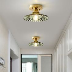 two lights are on above the sink in this white and gold bathroom, while another light is off