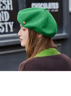 a woman wearing a green hat with buttons on the front and side of her head