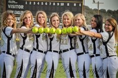 the women's softball team is posing for a photo with tennis balls in their hands