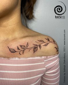 a woman's shoulder with leaves on it and the word love written in black ink