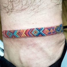 a man with a colorful bracelet on his ankle