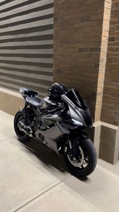 a black motorcycle parked in front of a building