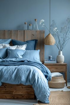 a bed with blue sheets and pillows in a bedroom