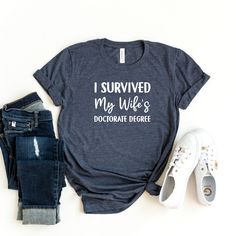 I Survived My Wife's Doctorate Degree Shirt is awesome gift idea for future doctor, medical student, or PHD Graduation Husband!                                                     ⭐  HOW TO ORDER   ⭐  1-) Please check all the photos from the listing. 2-) Please choose your shirt size and color. (Shirt sizes are shown on the listing photos) 3-) Please choose your quantity. 4-) Click add to cart. If you would like to order more than one shirt, you can easily go back to the listing and do the same thing for the other shirts you would like to purchase. 5-) Then please click Proceed to checkout. You are all set !                                                    ⭐  FABRICATION  ⭐  ⭐⭐ Our product distrubutor BELLA + CANVAS  is well known for their soft, and comfy clothing.  Our solid colors are Womens T Shirts Graphic Tees, Superhero Mom, Hippie Mom, Womens T Shirts, Mother Knows Best, Shirts Graphic Tees, Camping Glamping, Simple Tshirt, Secret To Success