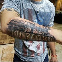 a man with a train tattoo on his arm