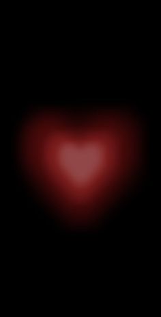 a blurry image of a red heart in the dark