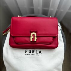 Furla Wonen Handbag 1927. Crossbody In Pop Red/Berry Color. Made In Elegant Leather With Featuring Chain Inserts. I Wore It Once. The Condition Is Perfect. Kept It In Holder. Length 10” ( 25cm) Width: 6 1/2” ( 17) Diagonal: 12” ( 30cm) Luxury Red Shoulder Bag With Turn-lock Closure, Chic Red Flap Bag With Gold-tone Hardware, Red Leather Bags With Turn-lock Closure, Classic Shoulder Bag With Turn-lock Closure For Shopping, Red Leather Shoulder Bag With Turn-lock Closure, Red Rectangular Shoulder Bag With Turn-lock Closure, Elegant Red Flap Bag For Shopping, Luxury Shopping Bag With Turn-lock Closure, Shopping Bag With Turn-lock Closure And Top Handle