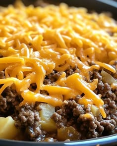 a casserole dish with ground beef, potatoes and cheese on top is ready to be eaten