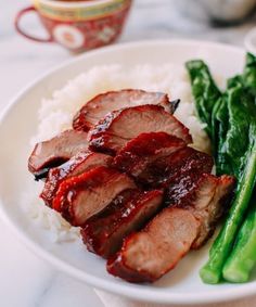 a plate with meat, rice and asparagus on it