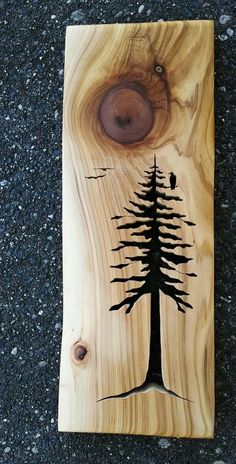 a piece of wood with a tree painted on it