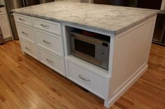 a kitchen with an oven, microwave and dishwasher on the counter top in it