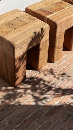 three wooden benches sitting on top of a brick walkway