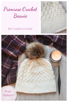 a crocheted beanie with a pom - pom on top and a candle