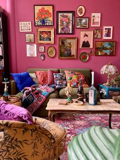 a living room filled with lots of furniture and pictures on the wall above it's coffee table