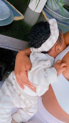 a woman is taking a bath in the tub with her hands wrapped around her head