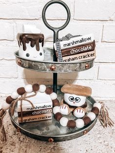 three tiered tray with chocolates, marshmallows and other items on it