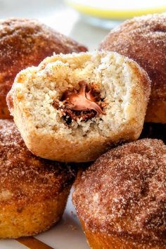 some sugared doughnuts are sitting on a plate