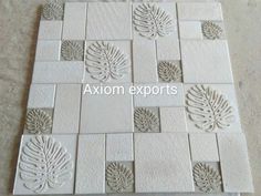 some white tiles with leaves on them and the words axiom experts written in it