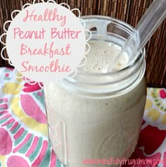 a glass jar filled with breakfast smoothie sitting on top of a colorful table cloth