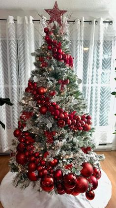 a christmas tree decorated with red and silver ornaments