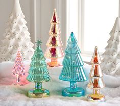 colorful glass christmas trees on snow covered ground